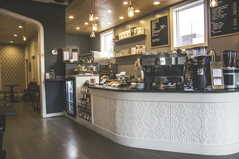 Café counter with espresso machines, grinders and cups ready for service