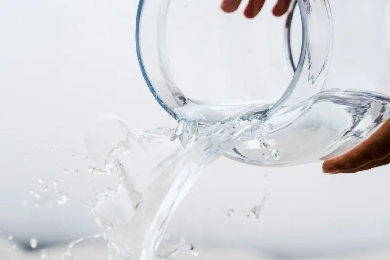 Clear glass jar tipped to pour out water